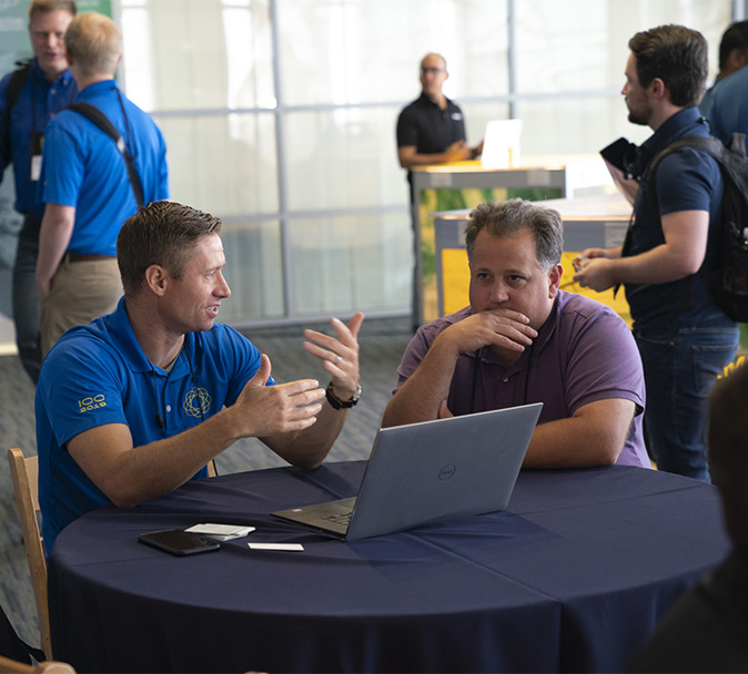 A representative and a customer sitting at a table discussing Ignition